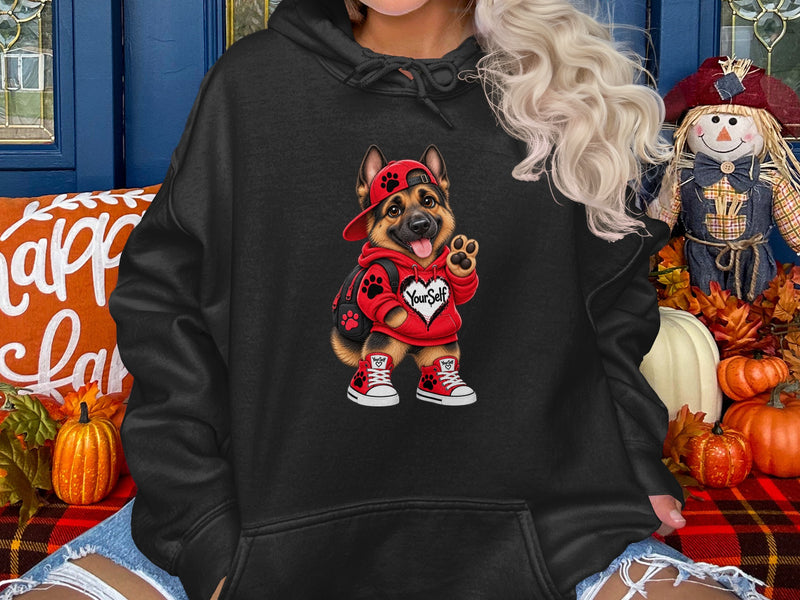 Load image into Gallery viewer, Black hoodie with a cartoon German Shepherd wearing a red hoodie and hat.
