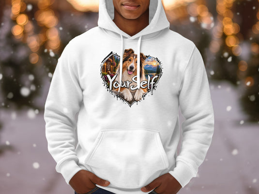 White hoodie with a heart-shaped graphic of a dog, cabin, lake, and mountains with text.