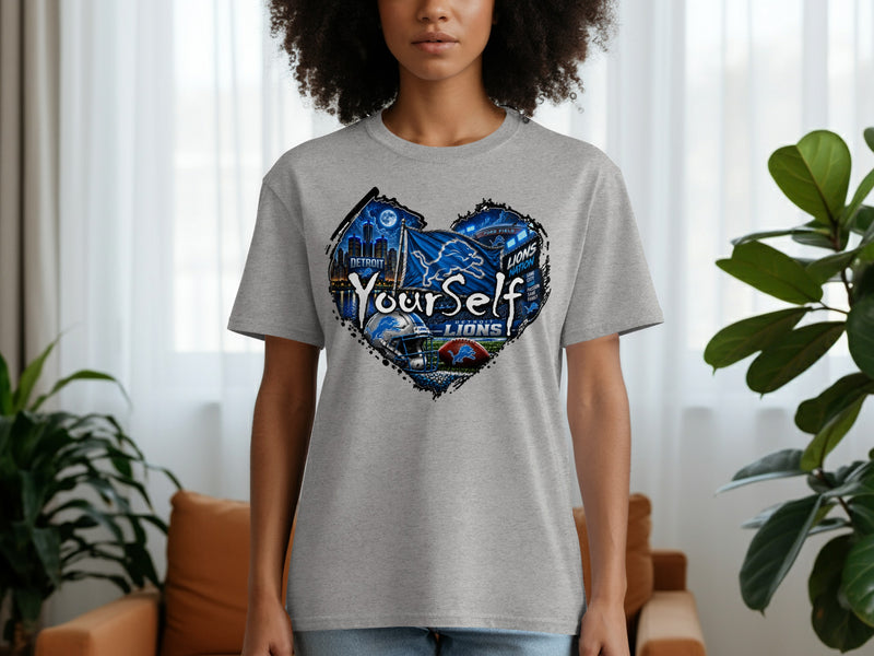 Load image into Gallery viewer, Gray t-shirt with Detroit Lions heart graphic featuring city skyline and football elements.
