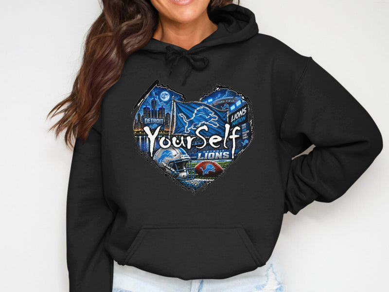 Load image into Gallery viewer, Black hoodie with Detroit Lions heart graphic featuring Ford Field and city skyline.
