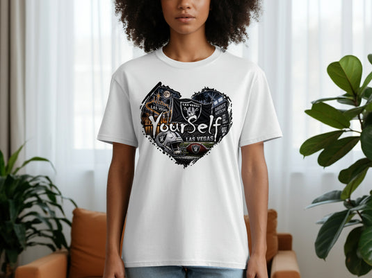 White t-shirt with a black heart graphic featuring Las Vegas scenes and Raiders imagery.