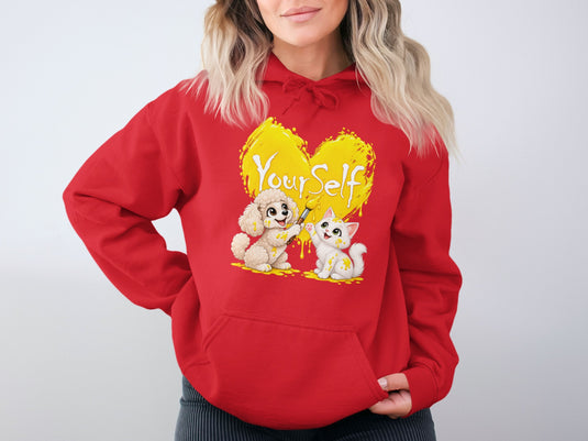 Red hoodie with a yellow heart graphic featuring a dog and cat painting "Your Self".