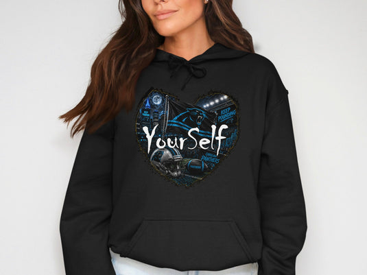 Black hoodie with heart graphic featuring Carolina Panthers logo, helmet, football, and stadium.