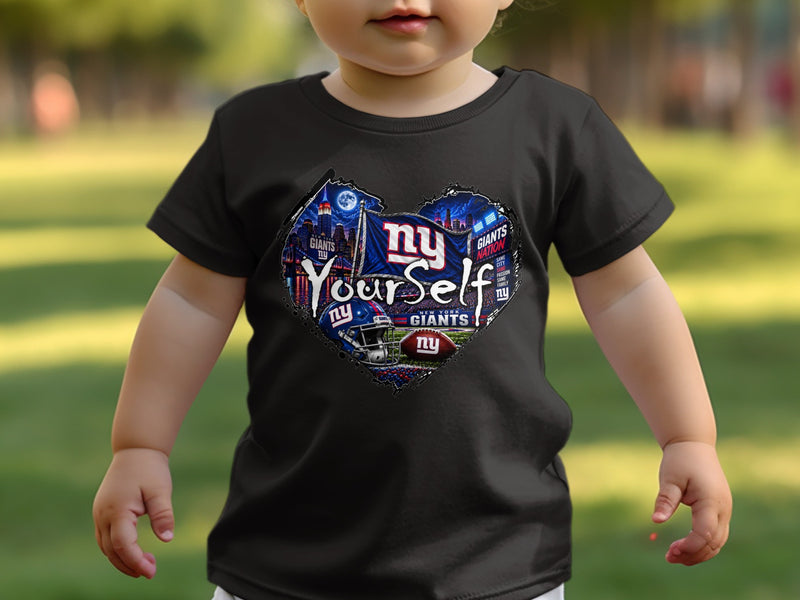 Load image into Gallery viewer, Toddler wearing black t-shirt with heart-shaped New York Giants graphic and "Be Yourself" text.
