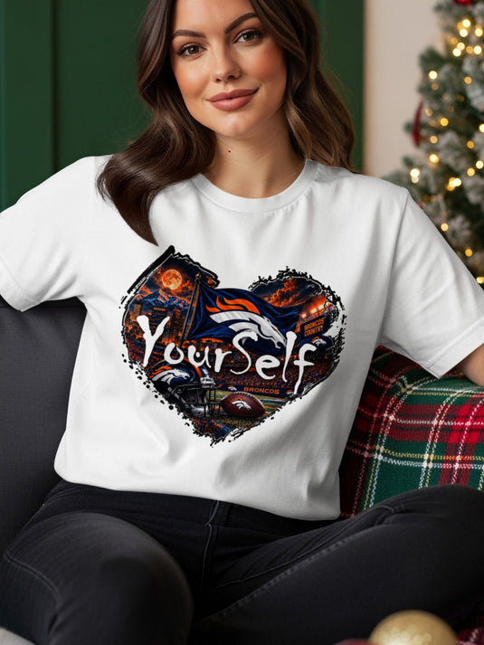 White t-shirt with a heart-shaped graphic featuring the Denver Broncos logo, stadium, and "Yourself".