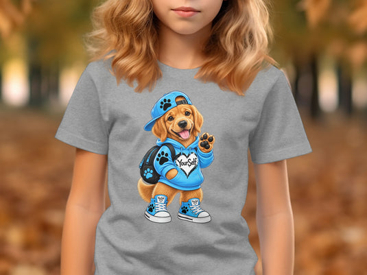 Golden retriever puppy wearing a blue hoodie, cap, backpack, and sneakers with "YourSelf" text.