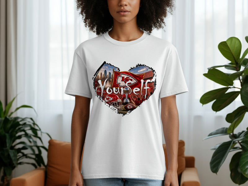 Load image into Gallery viewer, White t-shirt with a heart-shaped graphic of Kansas City Chiefs memorabilia and stadium.
