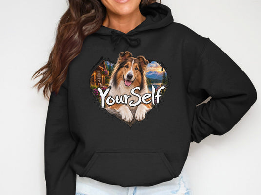 Black hoodie with a heart-shaped graphic of a Sheltie dog and mountains.