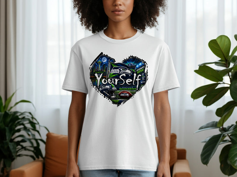 Load image into Gallery viewer, White t-shirt with heart graphic featuring Seattle Seahawks elements and "Your Self" text.
