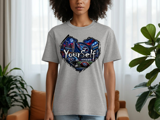 Gray t-shirt with heart graphic of Nashville skyline, Titans flag, helmet, and football.