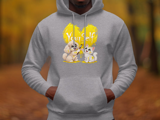 Gray hoodie with a yellow heart graphic featuring a dog painting "Yourself" and a cat.