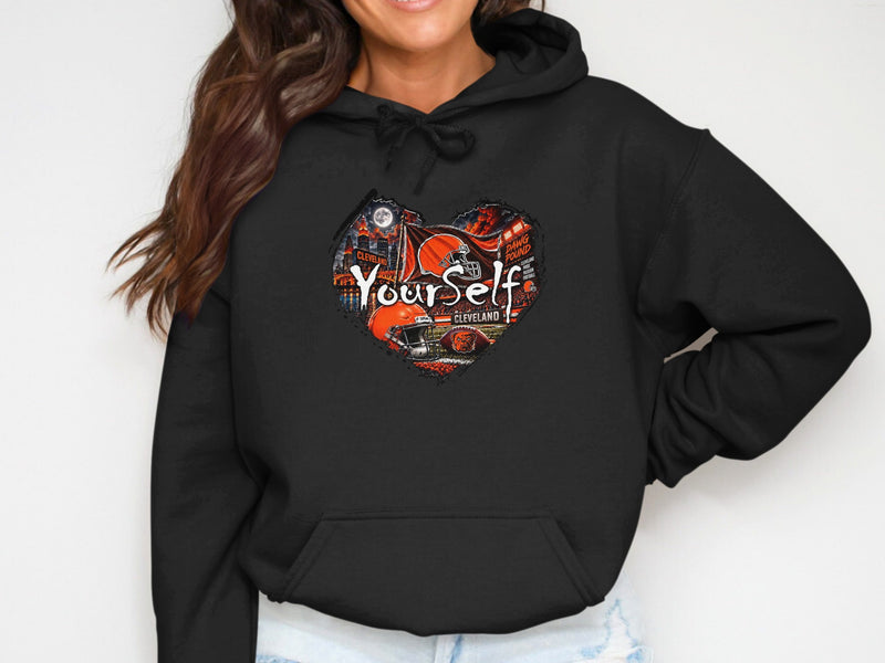 Load image into Gallery viewer, Black hoodie featuring a heart-shaped graphic with "YourSelf Cleveland" and football elements.
