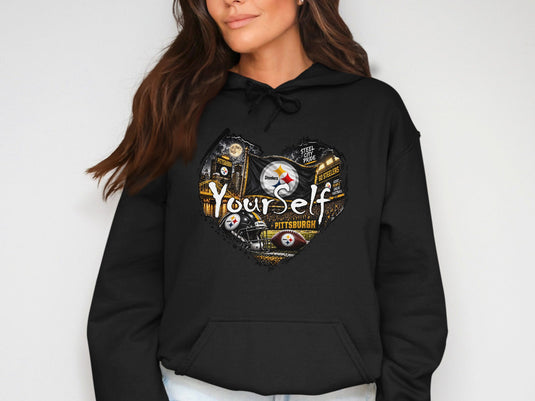 Black hoodie with Pittsburgh Steelers heart design featuring skyline, football, helmets, and text.