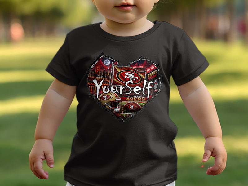 Load image into Gallery viewer, Toddler wearing a black t-shirt with a heart-shaped San Francisco 49ers graphic and the word "YourSelf".
