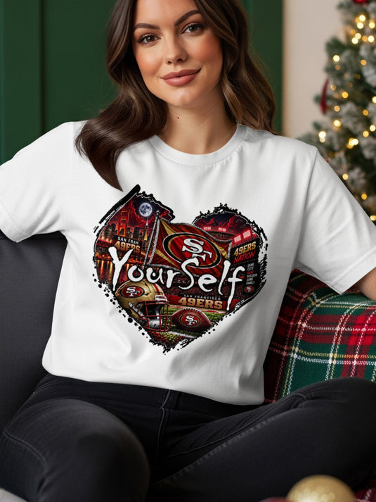 White t-shirt with heart graphic featuring San Francisco 49ers logo, football, and stadium.