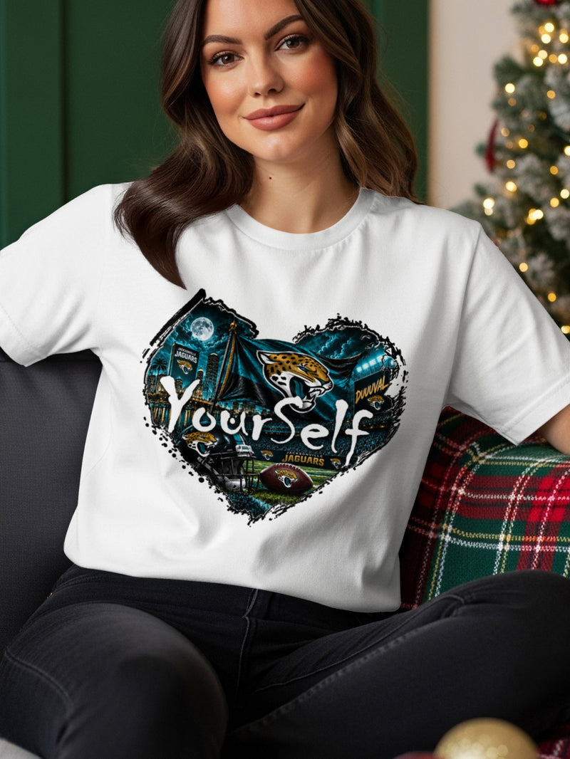 Load image into Gallery viewer, White t-shirt with a heart-shaped graphic featuring Jacksonville Jaguars logos, football, and stadium lights.
