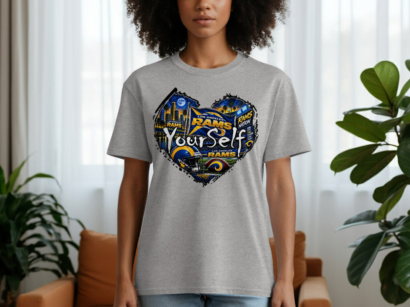 Load image into Gallery viewer, Los Angeles Rams heart graphic t-shirt featuring city skyline, football, and text.
